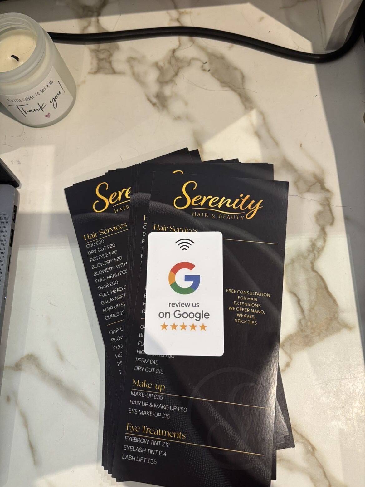 NFC review card sitting on Serenity Hair and Beauty's price list